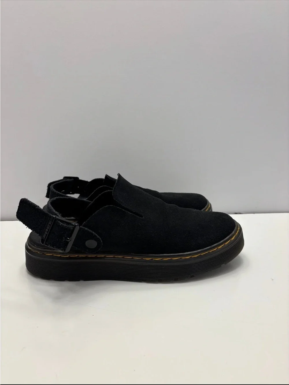 Dr. Martens Carlson slingback mules in black suede, with a chunky buckle